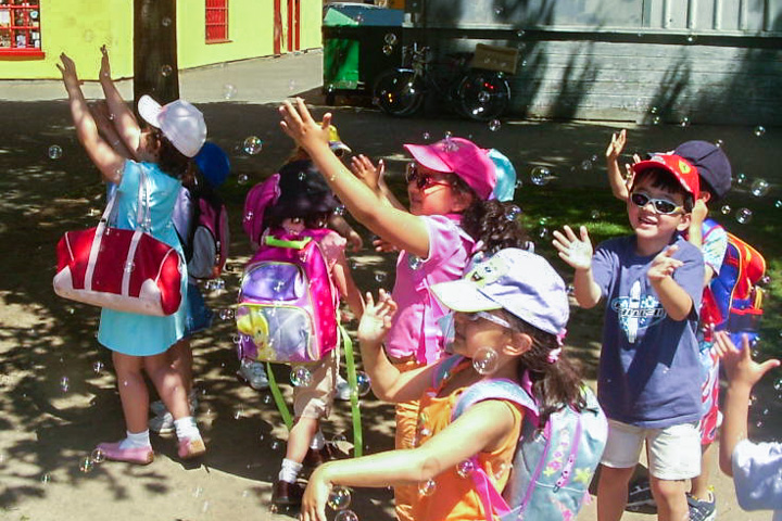 Children Playing with Bubbles